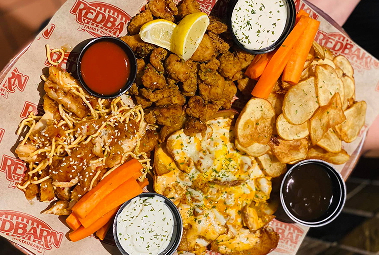 The appetizer platter at Red Barn Family Restaurant & Lounge includes: Sweet Chili Chicken, Greek Dry Ribs, Buffalo Chicken Skins and Dano’s Chips